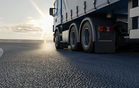 truck-is-driving-along-road-3d-image-3d-rendering.jpg