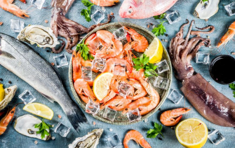 fresh-raw-seafood-squid-shrimp-oyster-mussels-fish-with-spices-herbs-lemon-light-blue-background.jpg