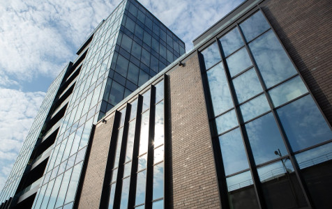 modern-office-building-with-glass-facade-blue-sky-business-background-modern-architecture.jpg