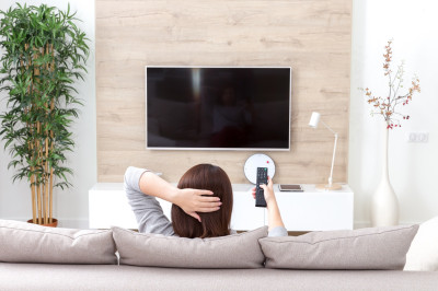 young-woman-watching-tv-room.jpg