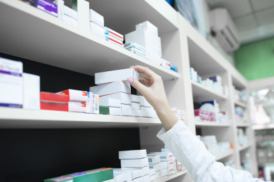 closeup-view-pharmacist-hand-taking-medicine-box-from-shelf-drug-store.jpg