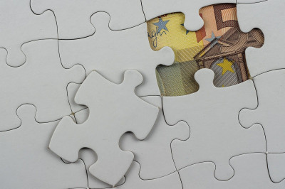 top-view-puzzle-pieces-with-money-it-concept-business.jpg