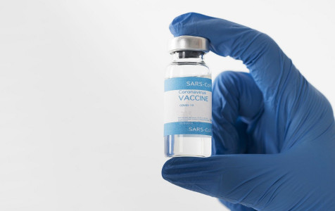 close-up-hand-holding-covid-vaccine.jpg
