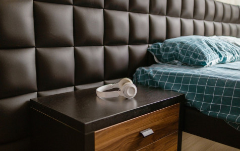 white-wireless-headphones-lie-bedside-table-near-bed-hotel-room.jpg