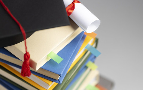 high-angle-stacked-books-graduation-cap-diploma-education-day.jpg