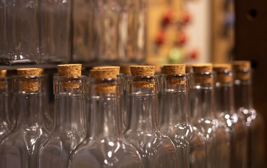 closeup-empty-glass-bottles-with-corks-blurred-background.jpg